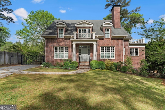 1116 Dan Johnson Rd NE, Atlanta, GA 30307 - view of front of house featuring a chimney, fence, a front lawn, a balcony, and brick siding