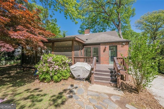 1884 Montrose Dr, East Point, GA 30344 - bungalow-style home with a wooden deck, a chimney, a sunroom, and brick siding
