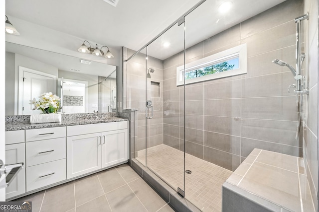 bathroom featuring a stall shower, vanity, and tile patterned floors