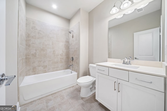 bathroom featuring vanity, tile patterned flooring, visible vents, toilet, and washtub / shower combination