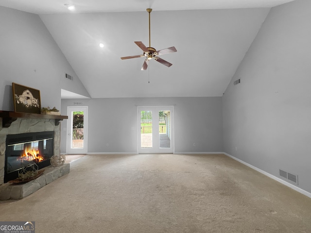 unfurnished living room with visible vents, a stone fireplace, baseboards, and carpet floors