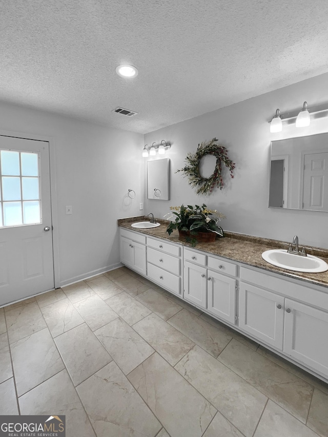 full bathroom with double vanity, visible vents, marble finish floor, and a sink