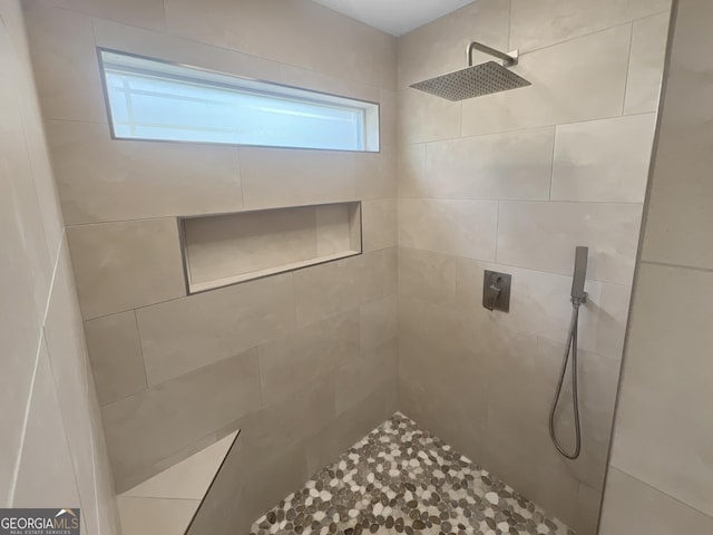 full bathroom with tiled shower