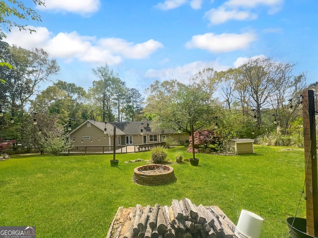view of yard featuring an outdoor fire pit
