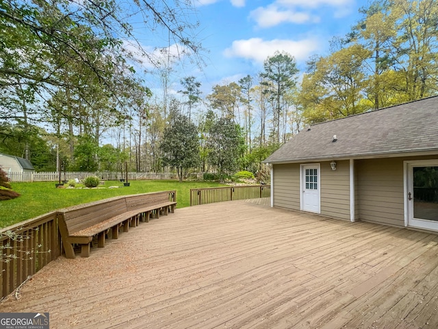 deck with a yard and fence