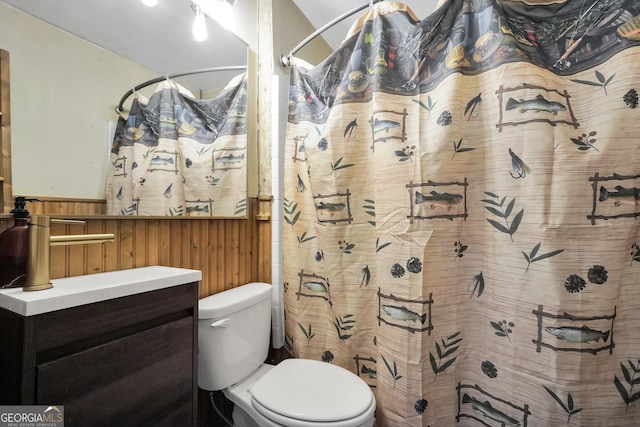 139 Cherokee Dr, Jackson, GA 30233 - bathroom with vanity, toilet, wood walls, a shower with shower curtain, and wainscoting