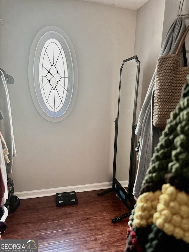 interior space with wood finished floors and baseboards