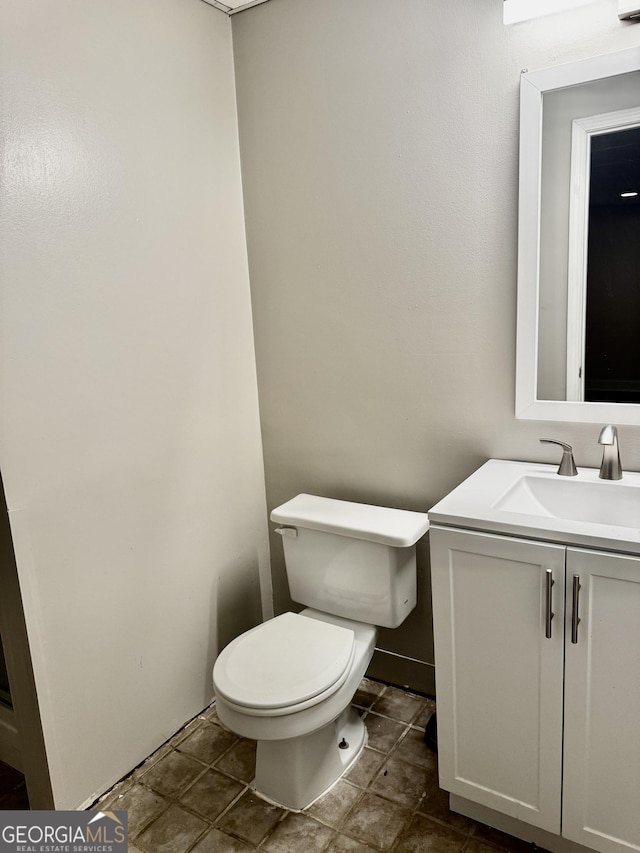 bathroom featuring toilet and vanity