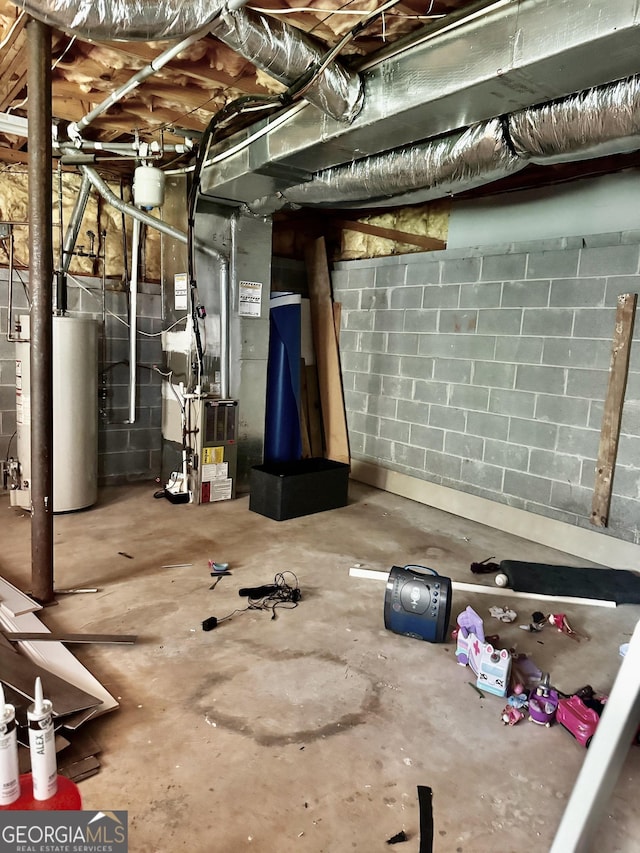 unfinished below grade area featuring concrete block wall, gas water heater, and heating unit