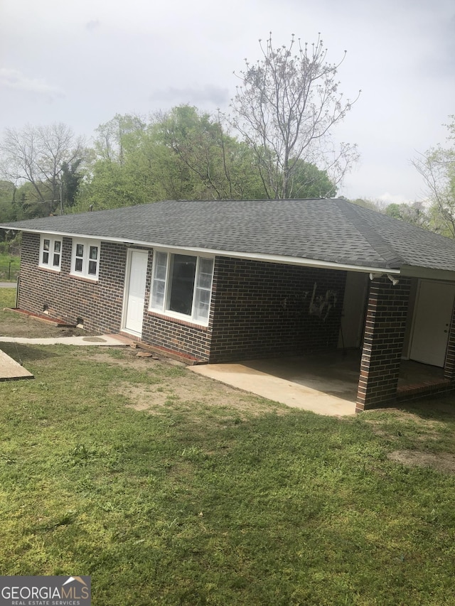 576 Pansy Ave, Macon, GA 31204 - ranch-style house with brick siding, a front lawn, and a carport
