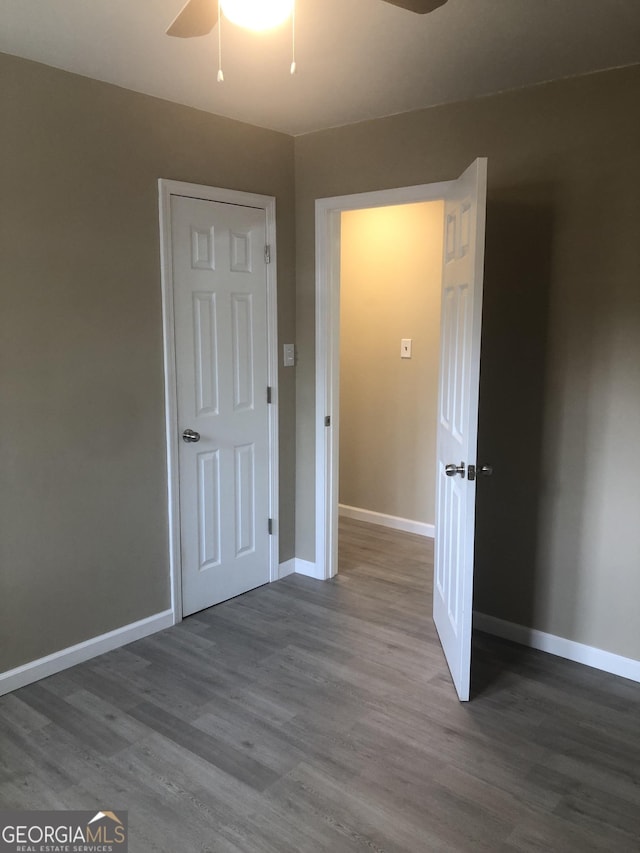 576 Pansy Ave, Macon, GA 31204 - unfurnished bedroom featuring baseboards, a ceiling fan, and wood finished floors