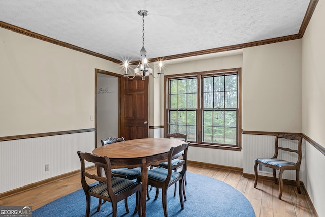 3588 SW Highridge Dr, Conyers, GA 30094 - dining room with a chandelier, wood-type flooring, wainscoting, and a textured ceiling