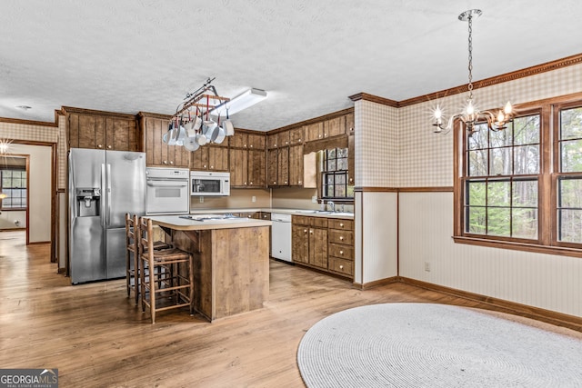 3588 SW Highridge Dr, Conyers, GA 30094 - kitchen with light wood-style flooring, white appliances, and wallpapered walls