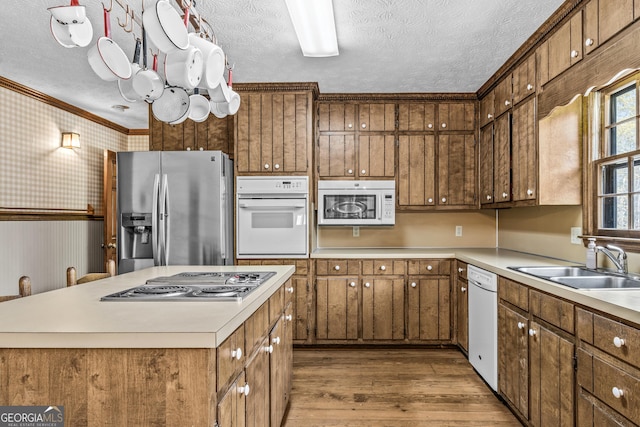 3588 SW Highridge Dr, Conyers, GA 30094 - kitchen with a textured ceiling, wood finished floors, wallpapered walls, and stainless steel appliances