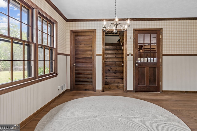 3588 SW Highridge Dr, Conyers, GA 30094 - entrance foyer with an inviting chandelier, visible vents, wood finished floors, wainscoting, and wallpapered walls