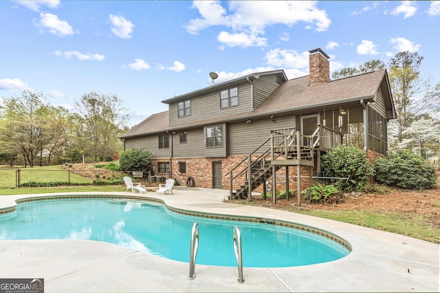 3588 SW Highridge Dr, Conyers, GA 30094 - pool featuring a sunroom, a lawn, a patio area, fence, and stairs