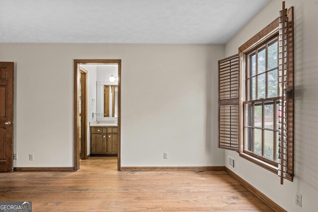3588 SW Highridge Dr, Conyers, GA 30094 - unfurnished bedroom featuring visible vents, baseboards, a textured ceiling, and wood finished floors