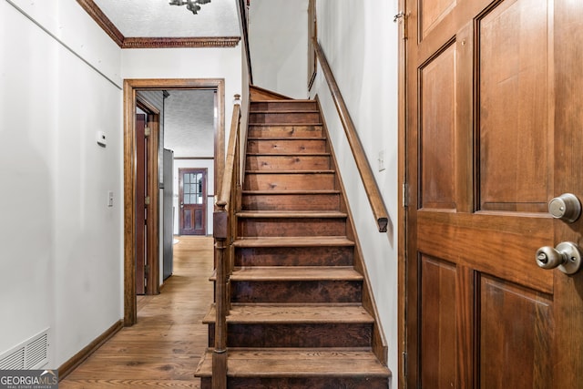 3588 SW Highridge Dr, Conyers, GA 30094 - staircase featuring visible vents, a textured ceiling, baseboards, and wood finished floors