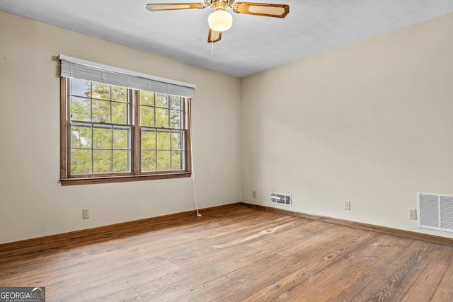 3588 SW Highridge Dr, Conyers, GA 30094 - spare room featuring visible vents, baseboards, a ceiling fan, and hardwood / wood-style flooring
