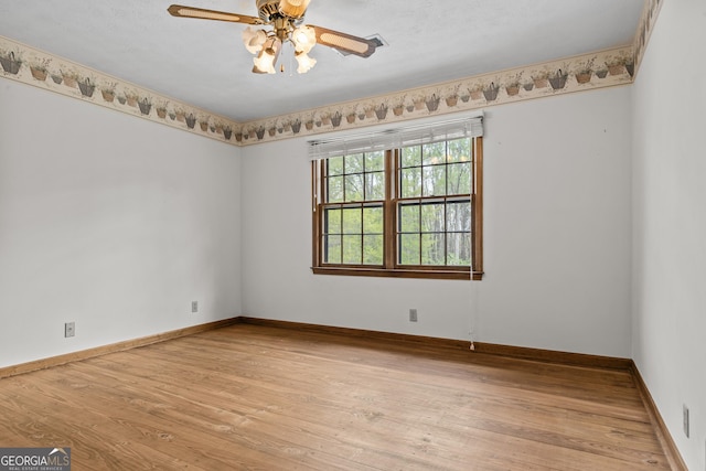 3588 SW Highridge Dr, Conyers, GA 30094 - empty room featuring visible vents, ceiling fan, light wood-style floors, and baseboards