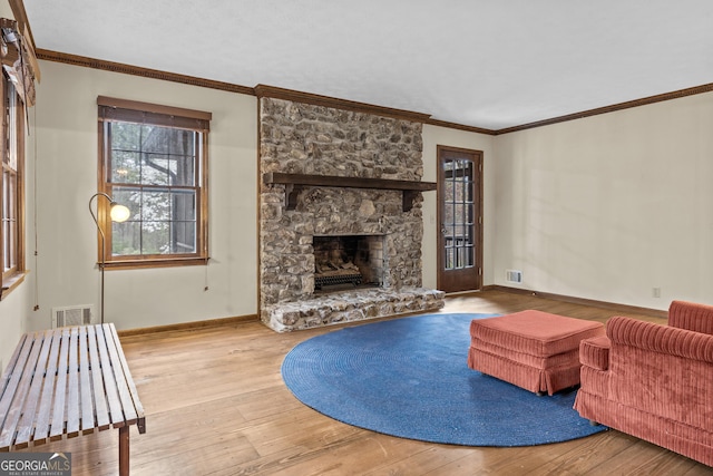 3588 SW Highridge Dr, Conyers, GA 30094 - living area featuring a fireplace, ornamental molding, visible vents, hardwood / wood-style floors, and baseboards