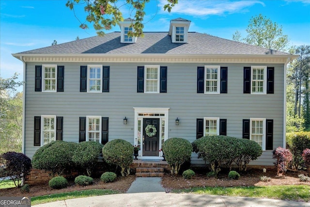 view of front facade with roof with shingles