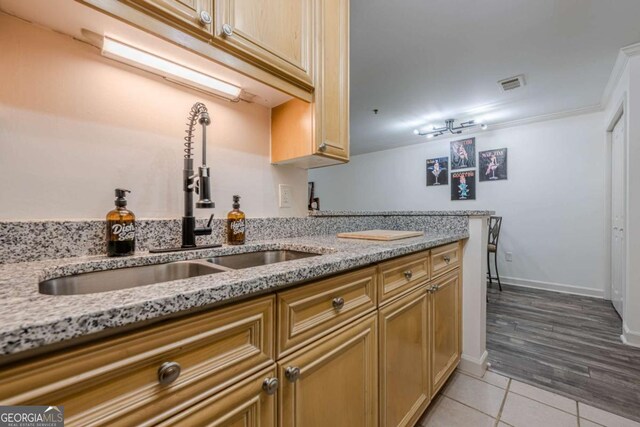 3203 Lenox Rd NE Unit 32, Atlanta, GA 30324 - kitchen with a sink, light tile patterned flooring, light stone countertops, and baseboards