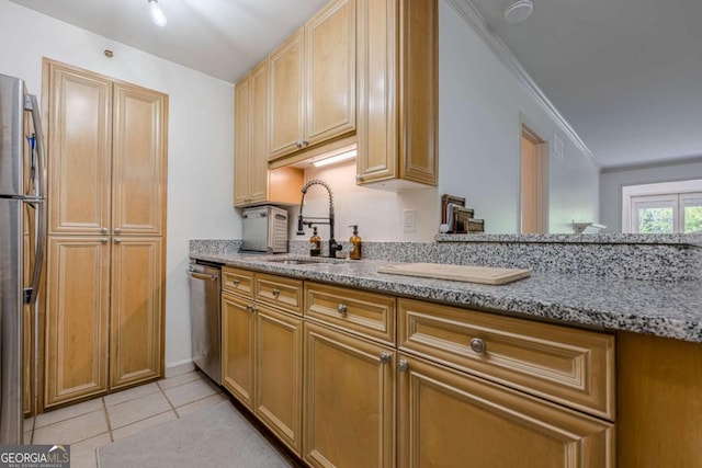 3203 Lenox Rd NE Unit 32, Atlanta, GA 30324 - kitchen with stainless steel appliances, light stone counters, a sink, light tile patterned floors, and crown molding