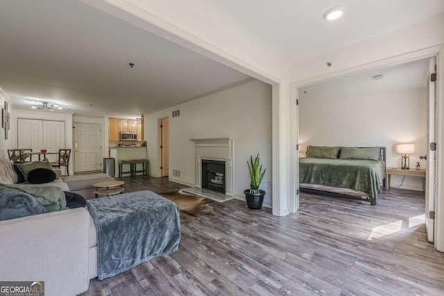 3203 Lenox Rd NE Unit 32, Atlanta, GA 30324 - living room with wood finished floors, a fireplace with raised hearth, and baseboards