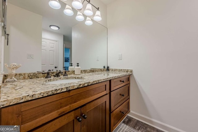 3203 Lenox Rd NE Unit 32, Atlanta, GA 30324 - bathroom with double vanity, wood finished floors, baseboards, and a chandelier