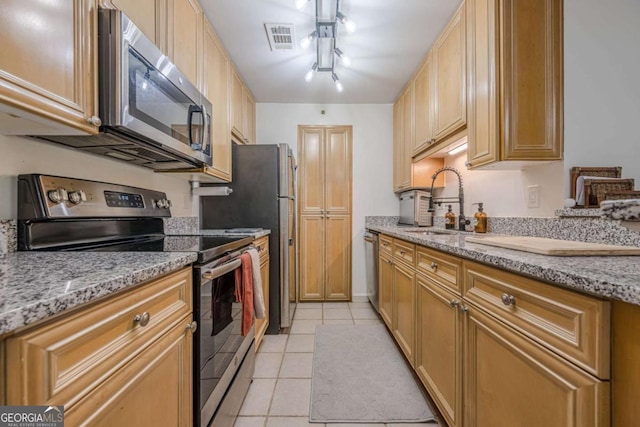 3203 Lenox Rd NE Unit 32, Atlanta, GA 30324 - kitchen with appliances with stainless steel finishes, light stone countertops, light tile patterned flooring, and a sink