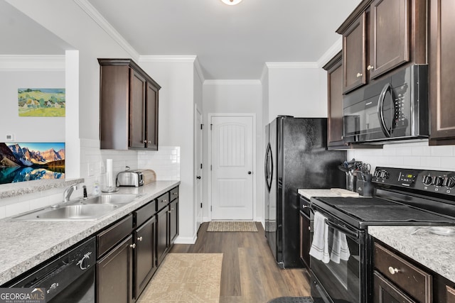 kitchen featuring dark brown cabinets, a sink, dark wood-style floors, and black appliances