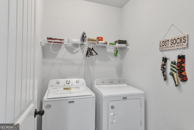 clothes washing area with washer and dryer and laundry area