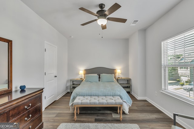 bedroom with wood finished floors, multiple windows, and visible vents