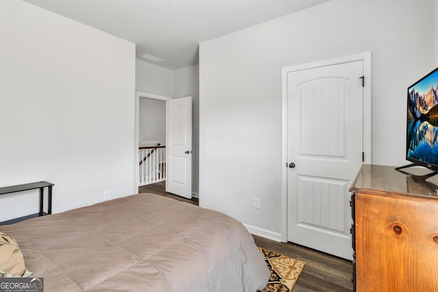 bedroom with dark wood-type flooring and visible vents
