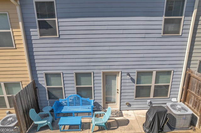 back of property with a patio area, cooling unit, and fence