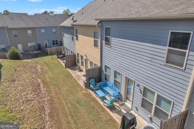 back of property with fence and a lawn