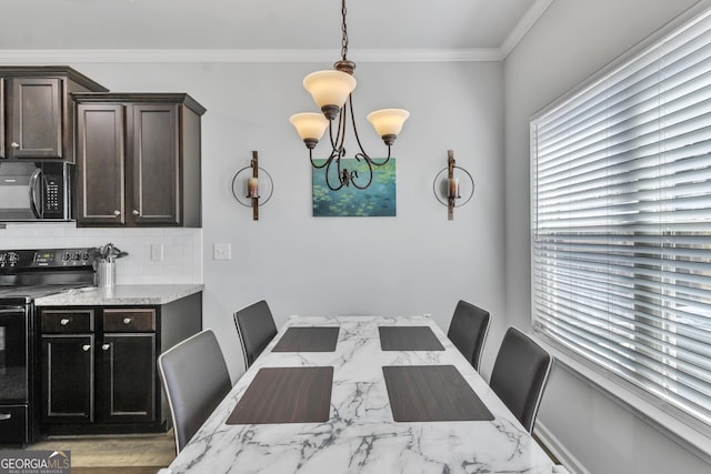 dining area featuring a notable chandelier and crown molding