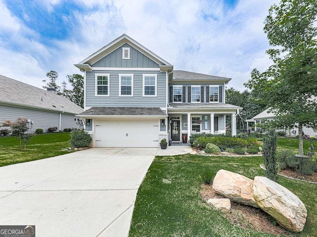 view of front of house with a garage, a front yard, board and batten siding, and concrete driveway
