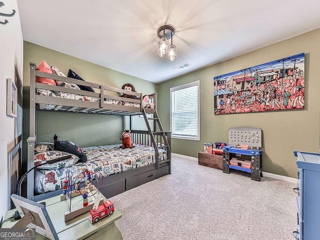 carpeted bedroom featuring visible vents and baseboards