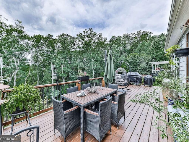 wooden terrace featuring outdoor dining area