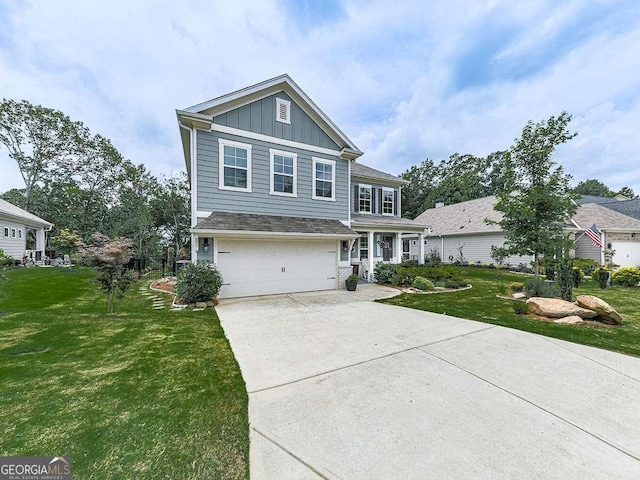 view of front of property with board and batten siding, a front yard, an attached garage, and driveway