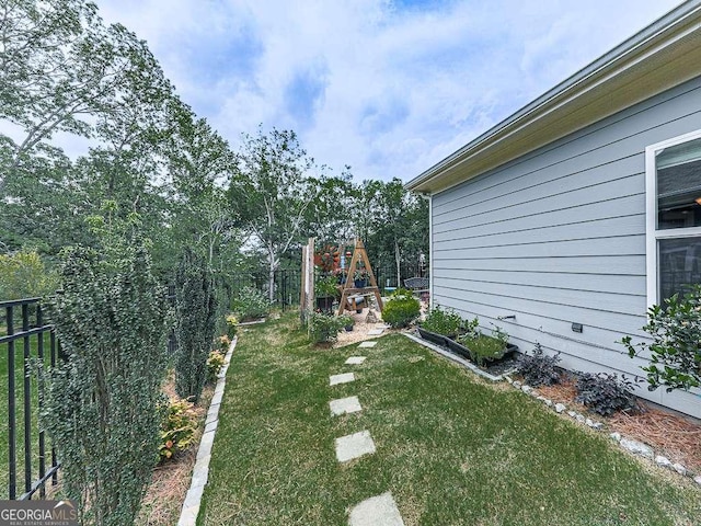 view of yard with fence and a playground