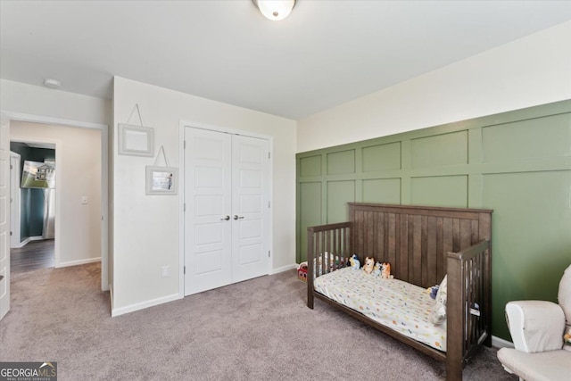 111 N Palmer St, Springfield, GA 31329 - carpeted bedroom featuring a crib, a closet, and baseboards