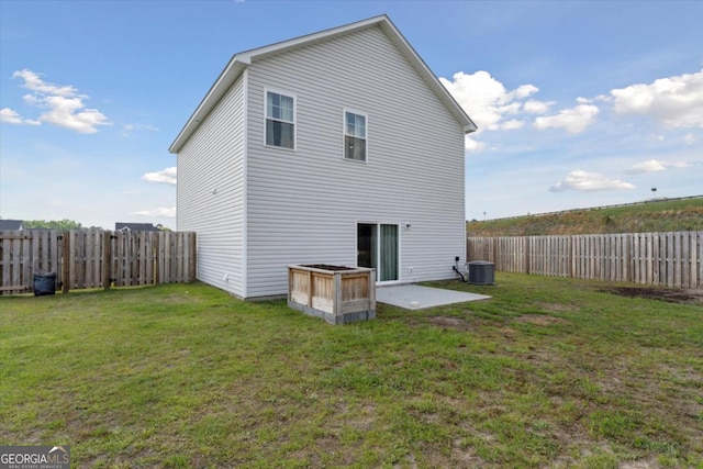 111 N Palmer St, Springfield, GA 31329 - back of property featuring a yard, a fenced backyard, and central AC