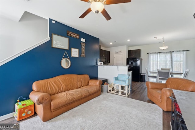 111 N Palmer St, Springfield, GA 31329 - living room with baseboards, an accent wall, a ceiling fan, recessed lighting, and dark wood-type flooring