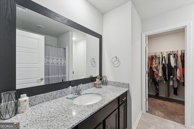 111 N Palmer St, Springfield, GA 31329 - bathroom featuring tile patterned floors, vanity, baseboards, and a spacious closet
