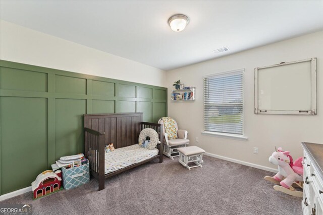 111 N Palmer St, Springfield, GA 31329 - bedroom featuring a decorative wall, carpet, visible vents, a crib, and baseboards