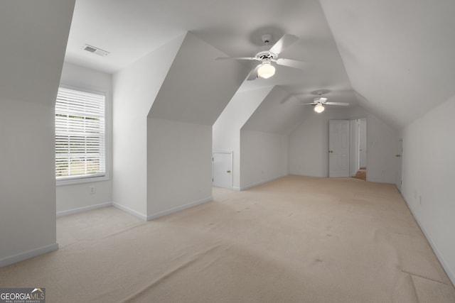 bonus room with lofted ceiling, carpet flooring, visible vents, baseboards, and a ceiling fan