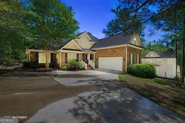 traditional home featuring an attached garage, brick siding, and driveway
